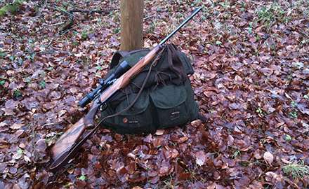 A hunting rifle and a hunting backpack