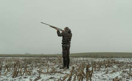 Hunter in hunting boots is shooting