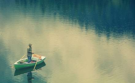A fisherman is on the boat