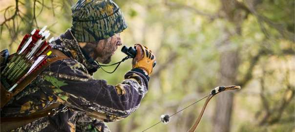 hunter is using hunting binoculars