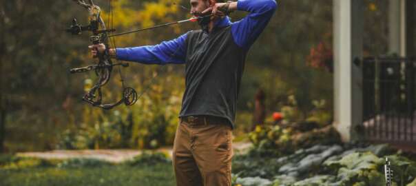 a man is bowfishing in the lake