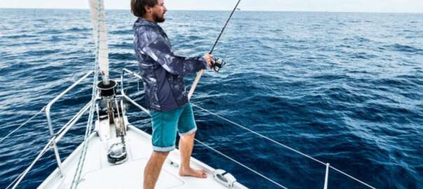 a man wearing fishing shirt on a boat