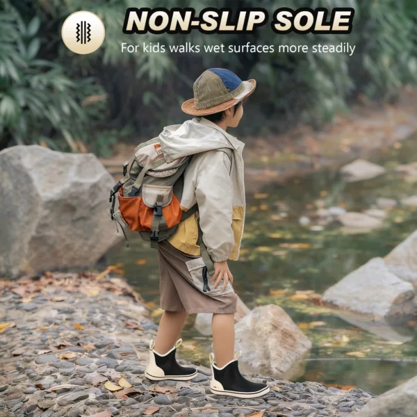 a boy is walking near a small stream, wearing Kalkal childrens black ankle boots